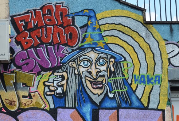 mural of a witch with wizard hat on blue with yellow stars