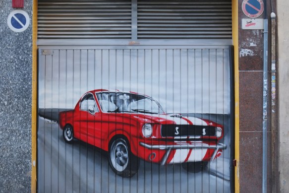 red ford mustang car with double white stripe down the front hood, roof and back 