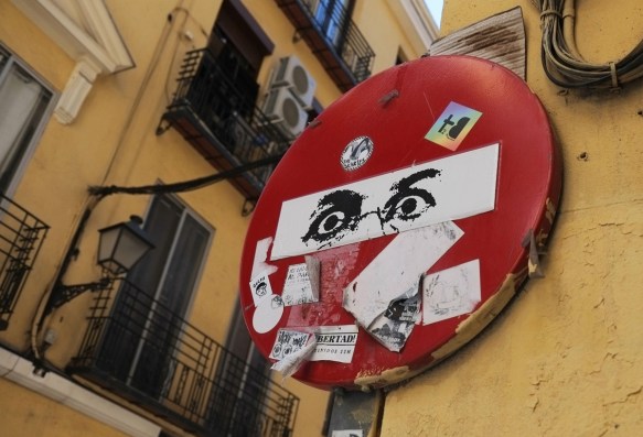 two black eyes on a do not enter sign, plus other stickers too 