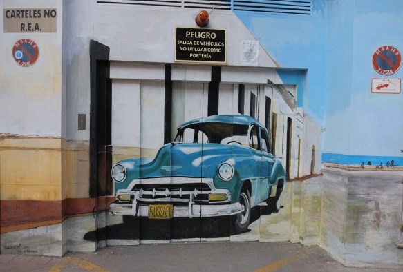 1950s blue car, American, licence plate says russafa, street art of an old car painted on a garage door 
