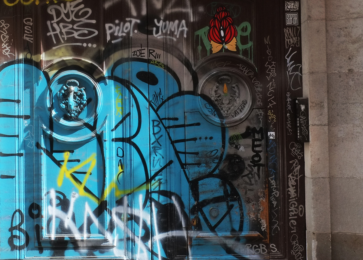 old wood door covered with blue tag and a sticker with a red flower