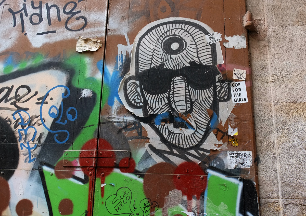 pasteup of a man's face, wearing black sunglasses, also his face is covered with black lines 