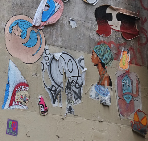 many pasteups on a wall