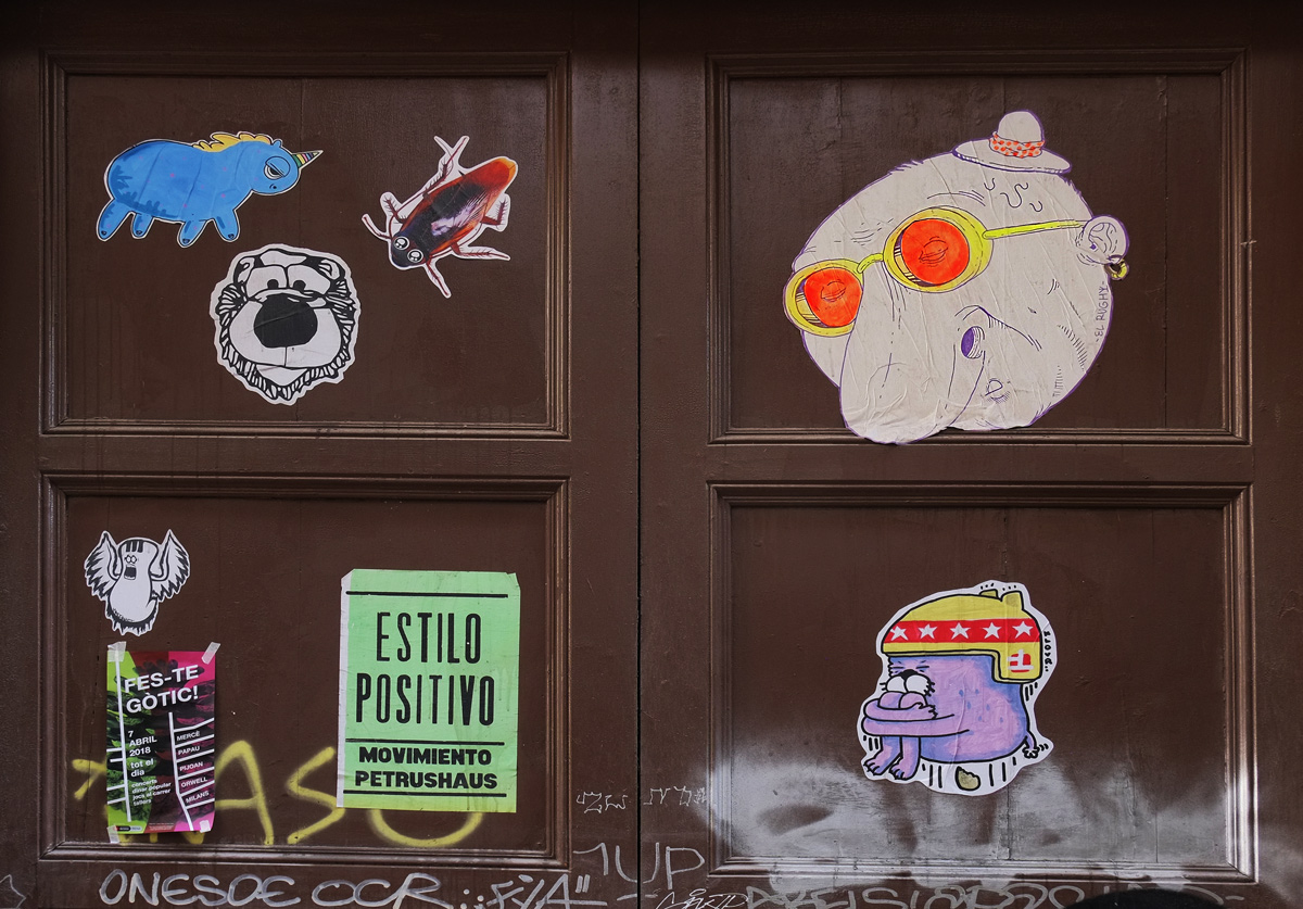 graffiti pasteups on a wooden door 