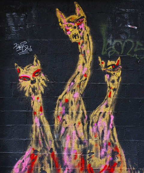 three long necked cats painting on a door 