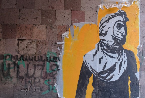 paste up of a person in black and white, hood and mask, yellow background 