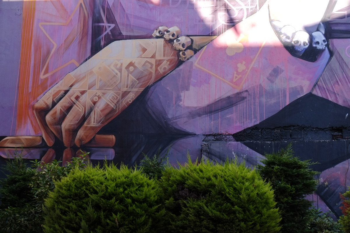 details of inti mural, hand with tattoos