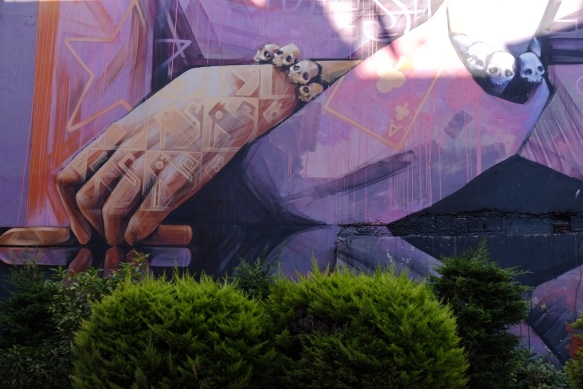 details of inti mural, hand with tattoos