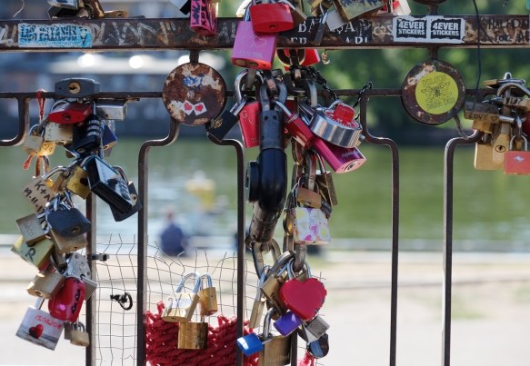 Some locks attached the bars of a metal gate in the old Berlin Wall on Muhlenstrasse, Eastside gallery