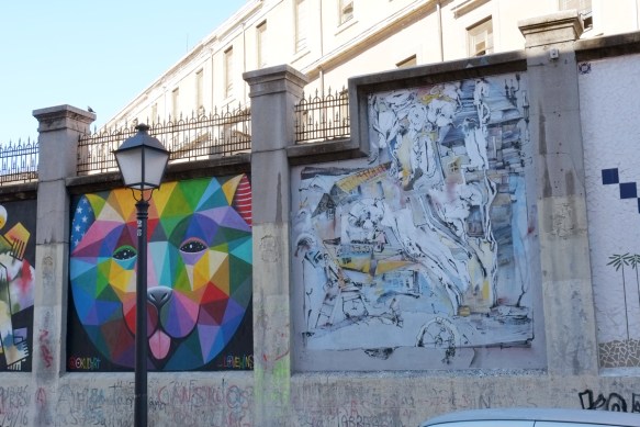 two murals, love wins by okuda and a piece by Laguna in pale turquoise and grey