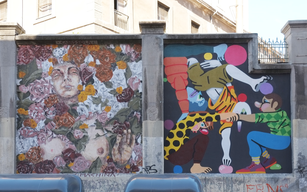two street art murals side by side, one is cartoonish and the other is a realistic woman surrounded by flowers (covering her)