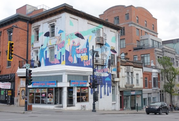 Mary Poppins mural by Antoine Tavaglione aka TAVA in Montreal at corner of Blvd St Laurent and rue Sherbrooke