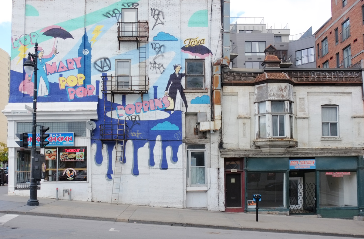 Mary Poppins mural by Antoine Tavaglione aka TAVA in Montreal at corner of Blvd St Laurent and rue Sherbrooke 