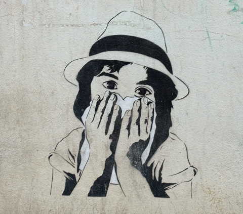 stencil of a young girl's head, shoulders and arms, wearing a hat, holding a piece of fabric over her mouth and nose 