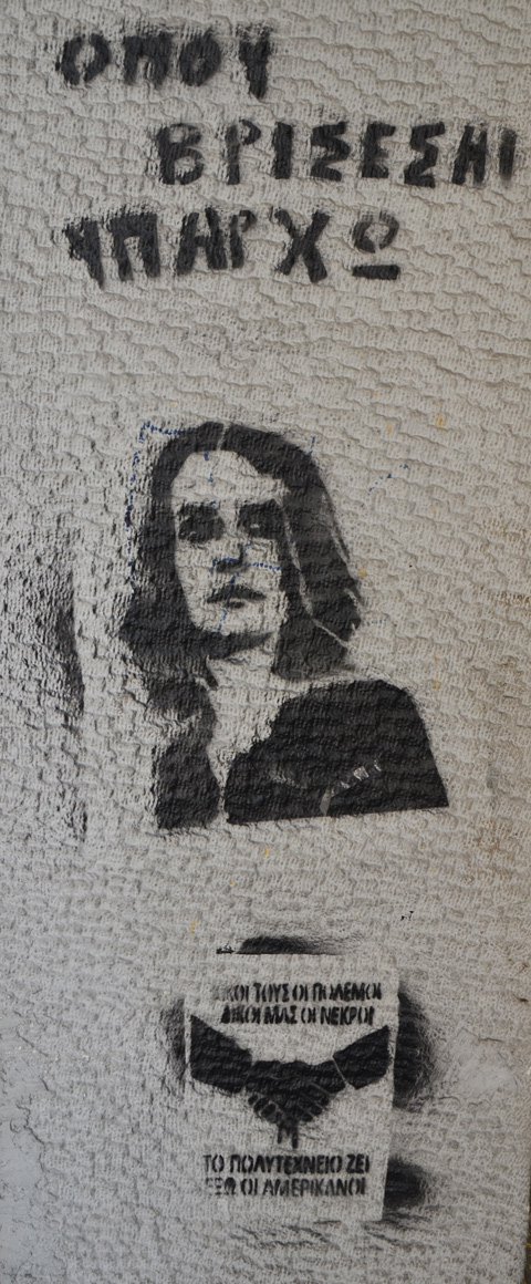 black stencil of a woman on a concrete pole