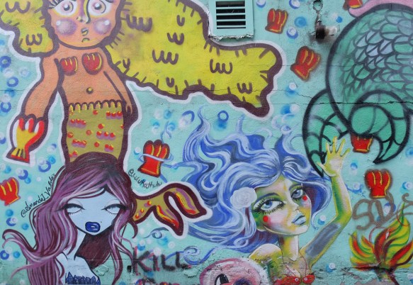 a mural with three different mermaids by three different artists 