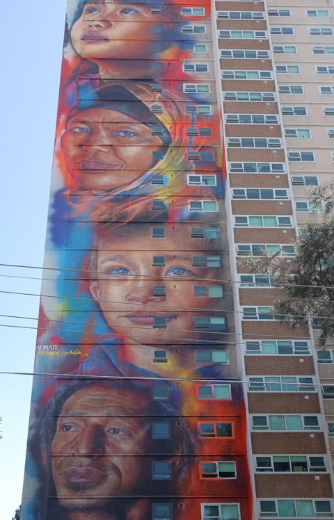 adnate faces, four, on a 20 storey high apartment building 