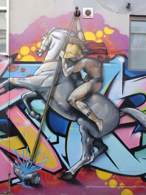 street art painting, man on horse with long lance, or sword, on horse back, horse rearing up on hind legs, 