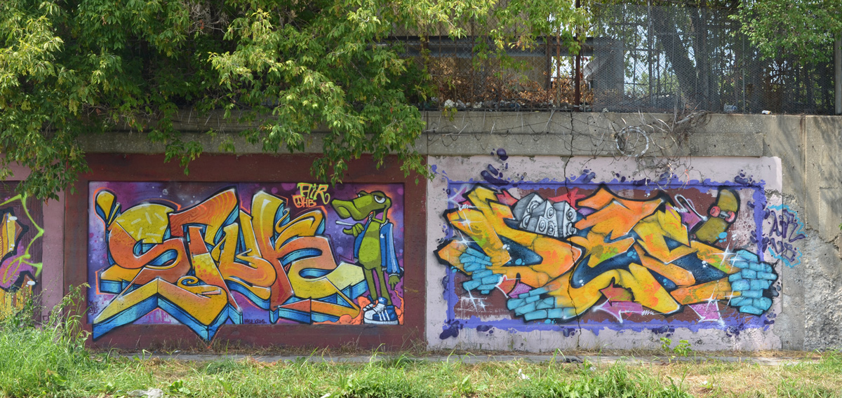 two murals on a wall, one with green lizard character