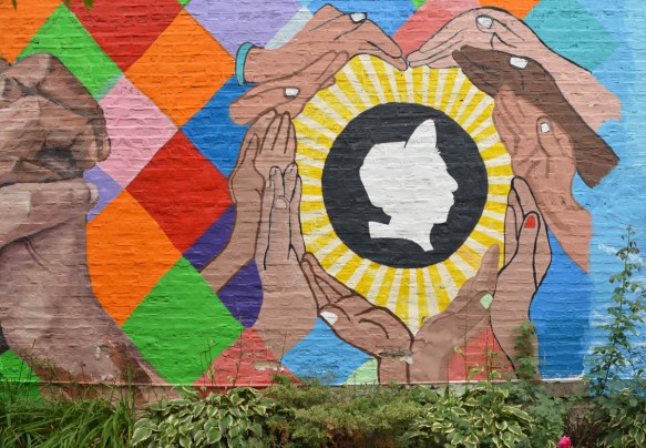 hands forming a heart shape around a man's profile in white 