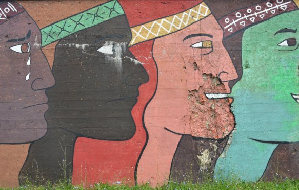 mens faces in profiles in different colours, large, about 10 feet tall, mural on a wall beside the railway tracks in Pilsen Chicago, Galeria del Barrio