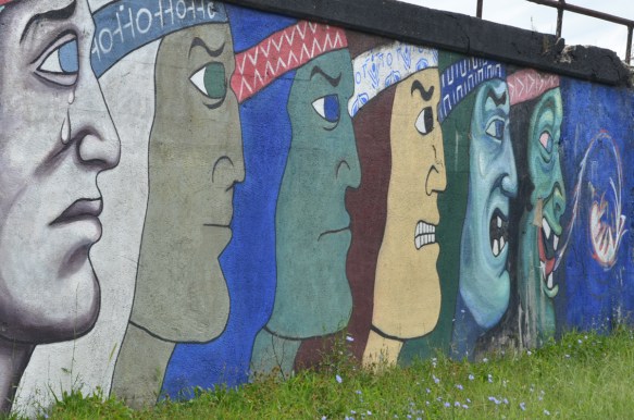 mens faces in profiles in different colours, large, about 10 feet tall, mural on a wall beside the railway tracks in Pilsen Chicago, Galeria del Barrio