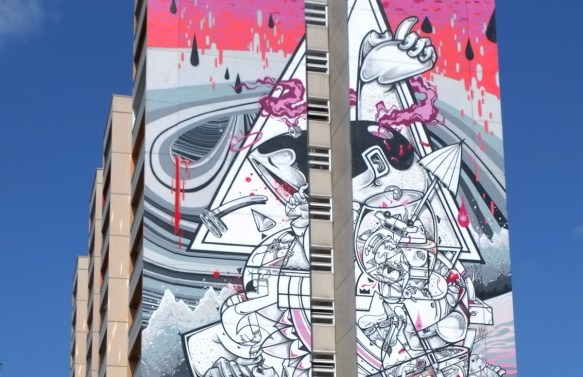close up of top of mural by How and Nosm, watermelon dripping, Urban Nation Tegel Art Park, large mural on side of 13 storey building, 