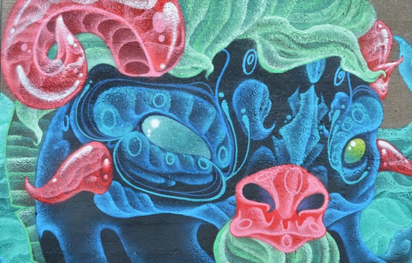 pink nose, pink horns, green hair, blue face and eyes, mural