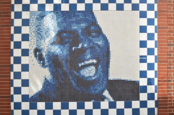 mural of a black man singer made in tiles in blacks and white with shades of blue