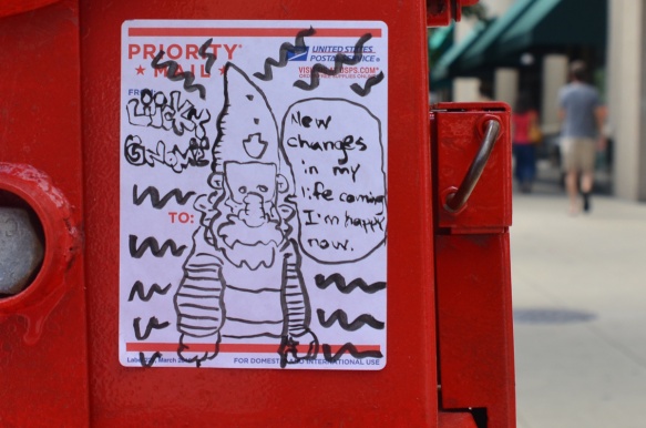 a sticker made with a USA postal sticker, picture of a gnome with words, 