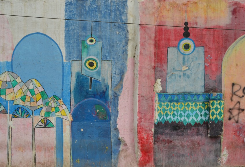 streeet art mural of two mosques with red sky behind