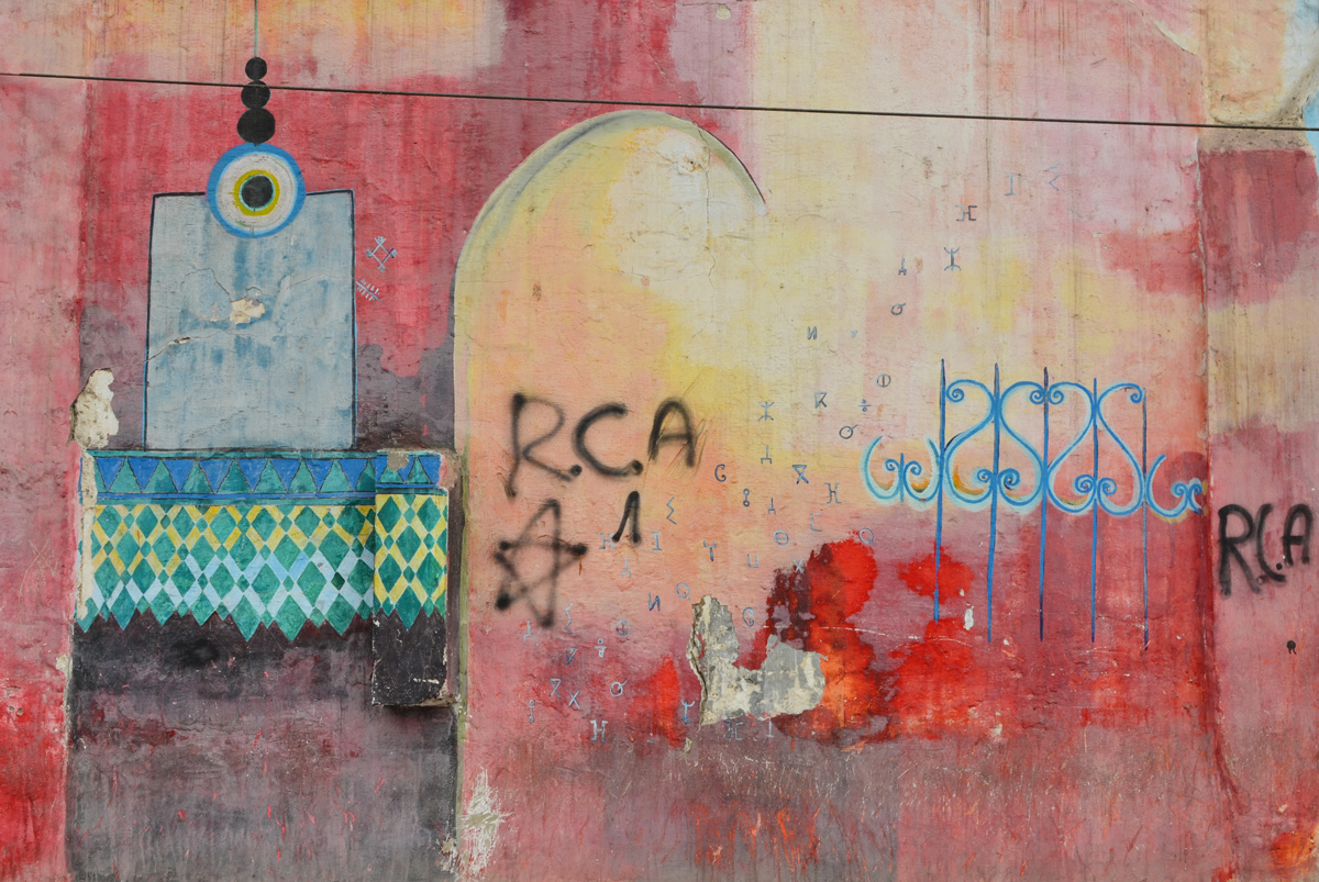 mosque with red sky, some tagging by RCA, mural