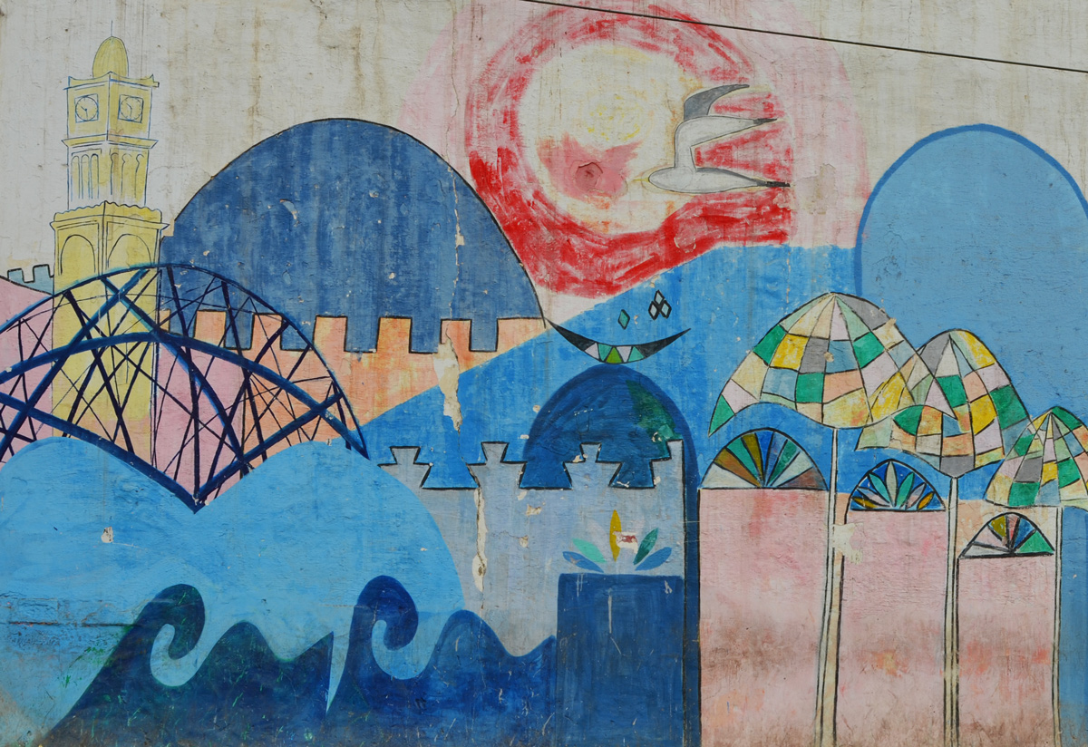 red sun, blue waves, hussan 2 mosque, brown wall, umbrellas, casablanca scene painted in a mural