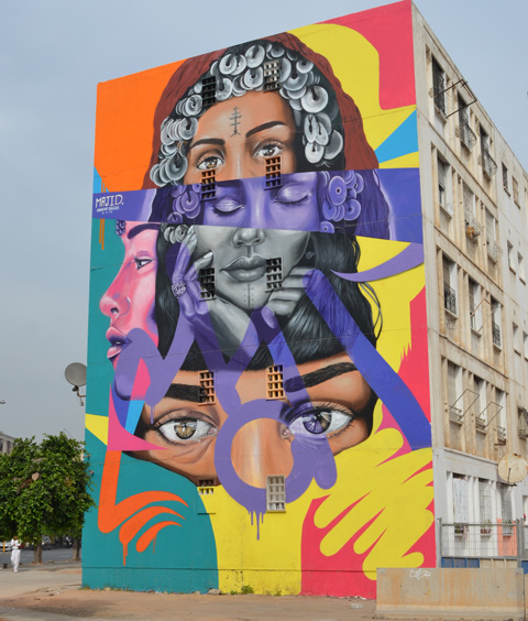 large mural of womens faces in different horizontal stripes