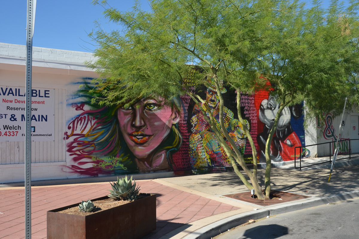 three murals in a row by Nicholai Khan, with #thinkvegas written by them, a woman's face, Charlie Chaplin, and Mickey Mouse 