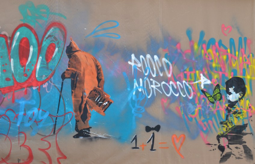 in a mural, an old man with a can and long orange coat with hood walks away, 1 plus one equals a heart