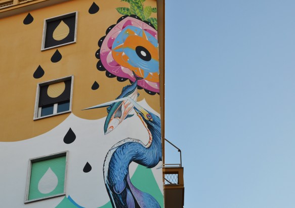 Upper part of a large mural called Hunting Pollution by Federico Massa also known as Iena Cruz, of a heron with a fish in its beak