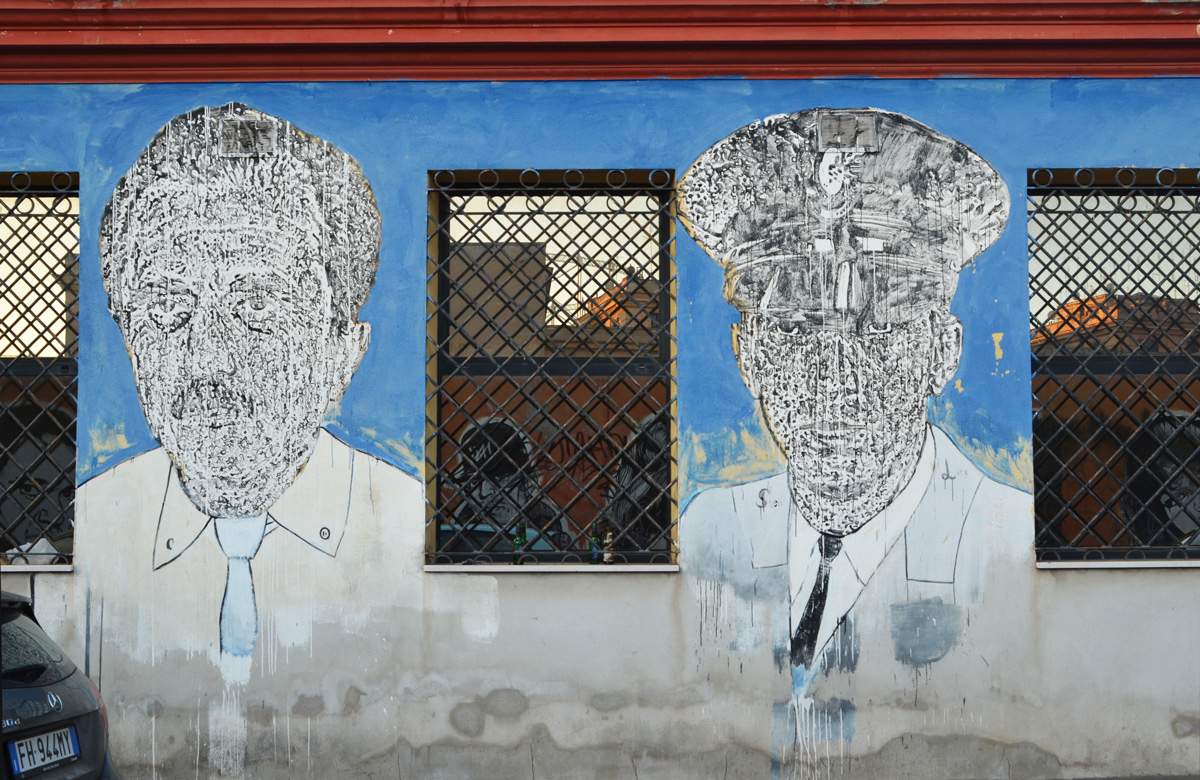 large portraits by sten and lex, Italian street arts, in a mural on two sides of the street, of famous people and common people, 