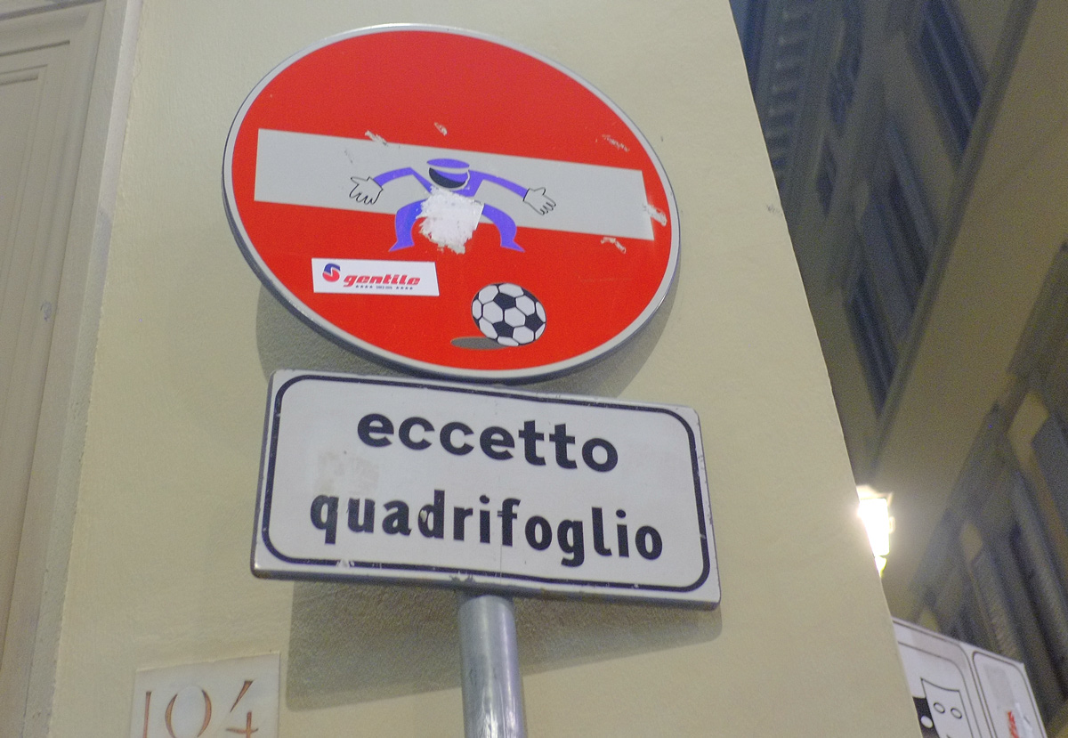 altered red and white no entry sign, graffiti by Clet Abraham, of a football goalie defending his net