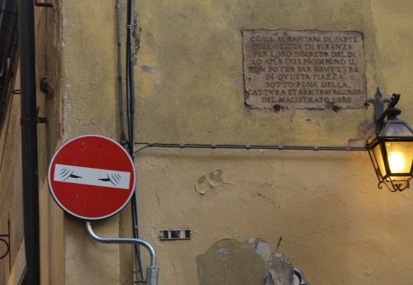 altered red and white no entry sign, graffiti by Clet Abraham, of a woman in a veil covering all but her eyes