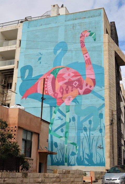 pink flamingo on turquoise background, a mural 