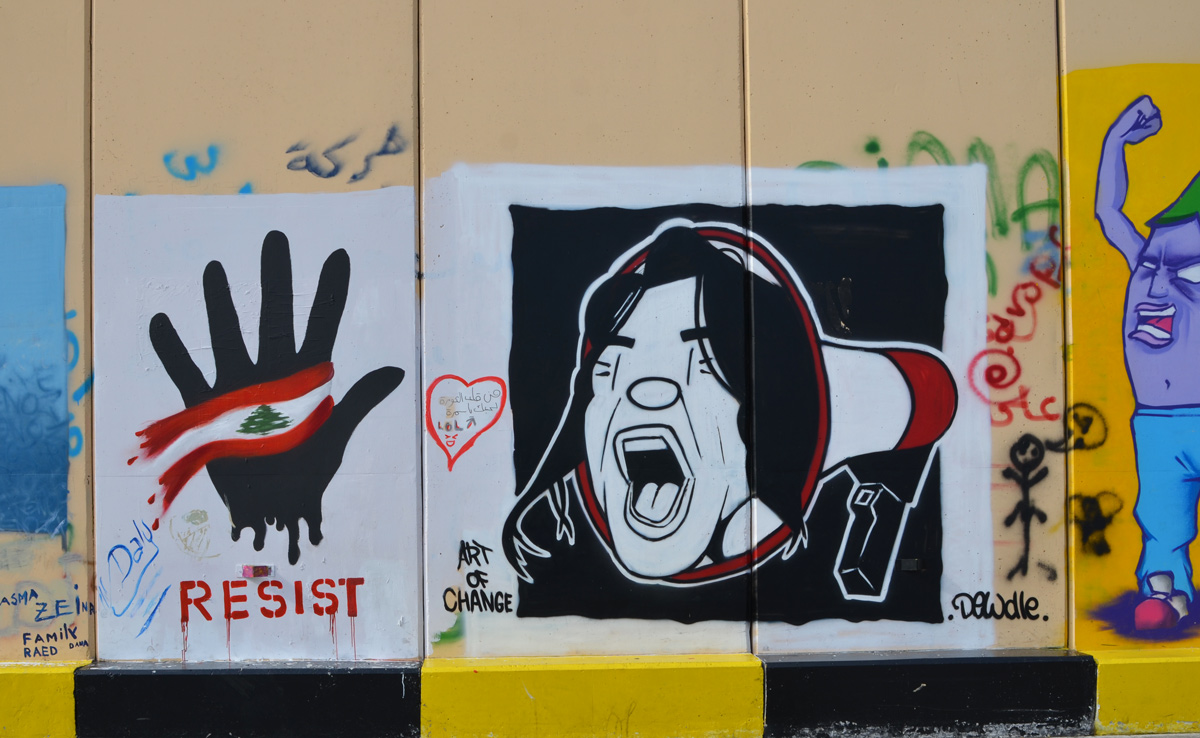 a black hand with a Lebanese flag over the palm beside a man's face, shouting with eyes closed, coming out of a megaphone, street art protest piece 