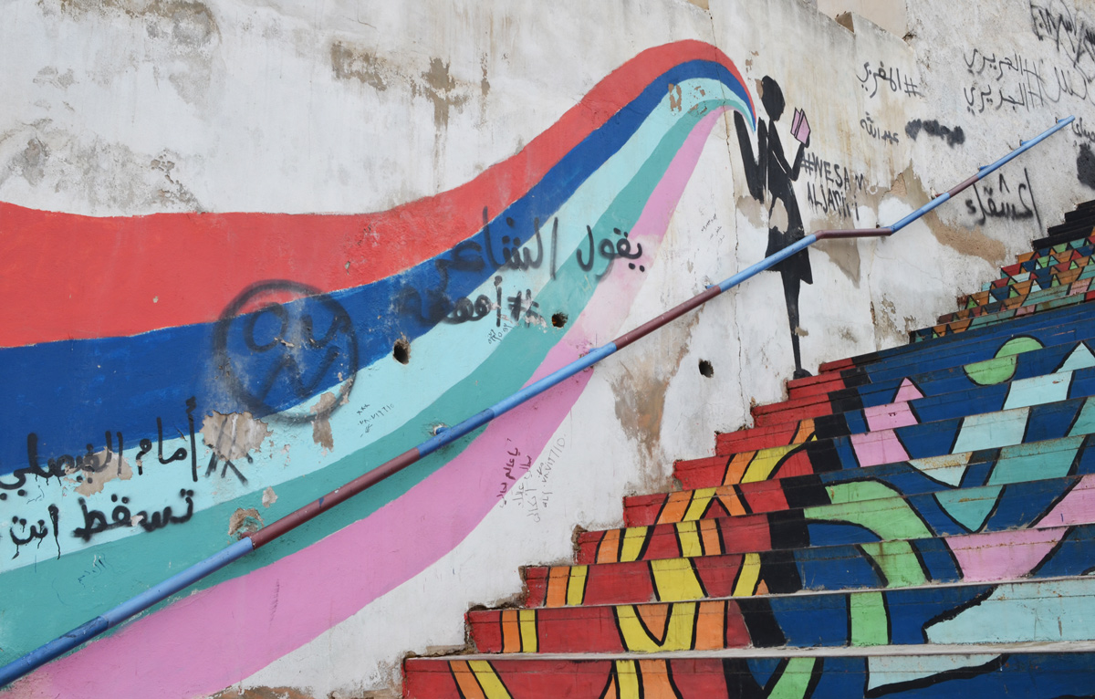 black silhouette of a girl with a backpack on, reading a book, colours flow from ther backpack in a long wave down the stairs 