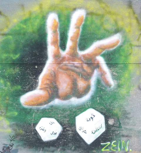 street art of a hand throwing a pair of dice