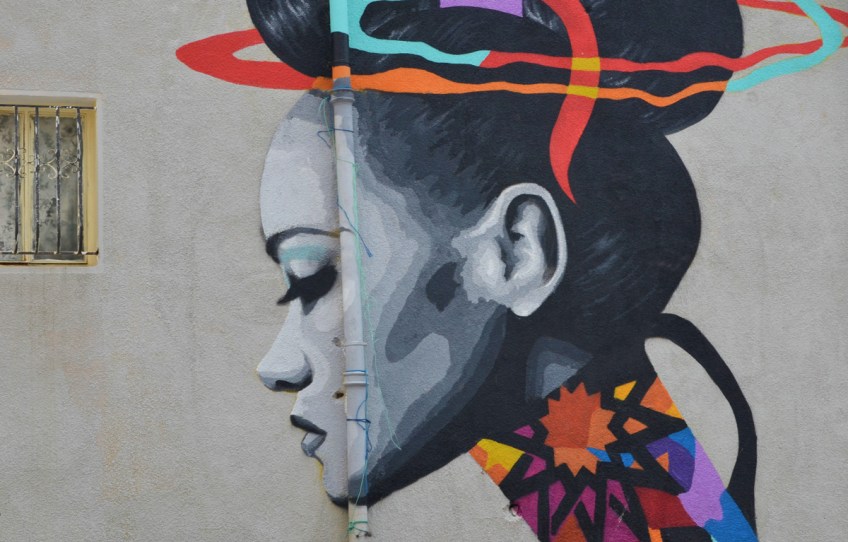close up of the head, a woman in profile, in the mural painted by Dina Saadi