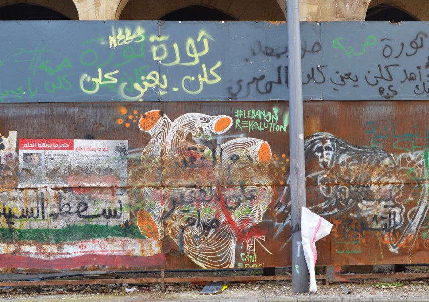 graffiti on a wall icluding a large heart that is anatomically close to real