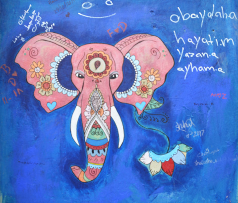 on a blue background, street art painting of pink elephant's head, frontal view, with Indian symbols on it 