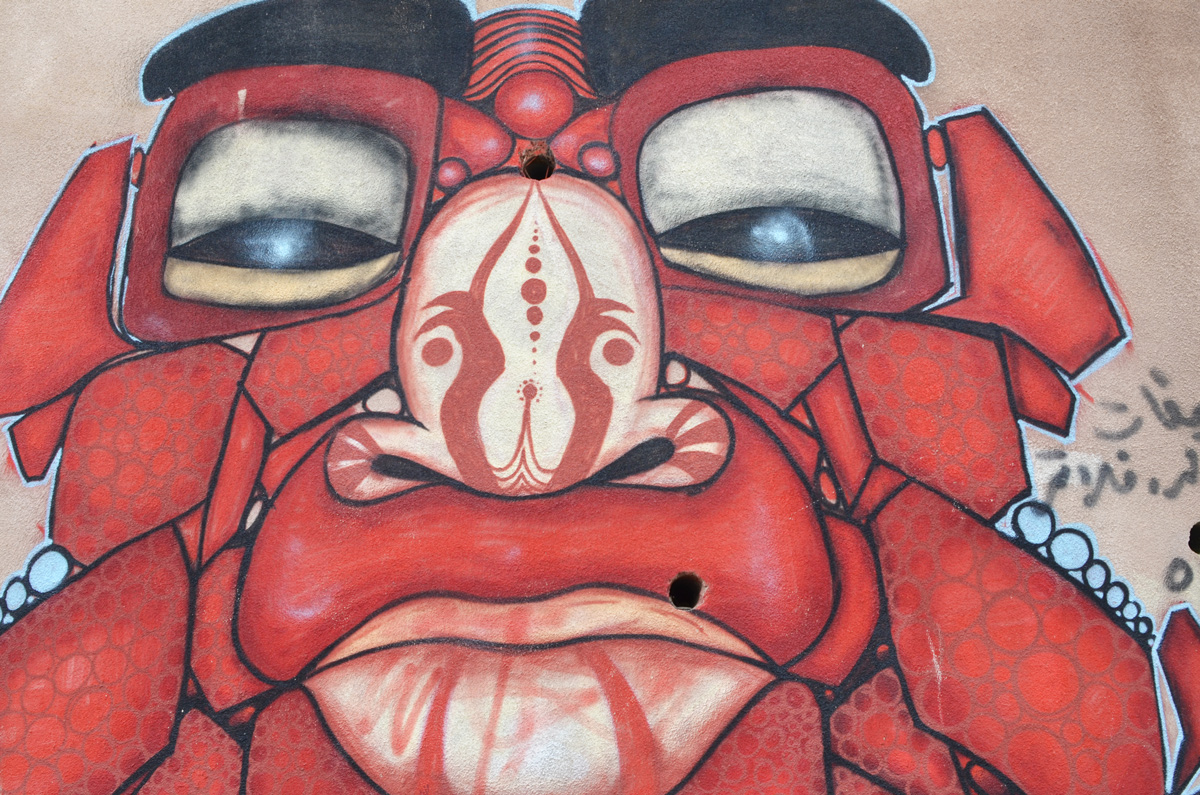 red monster face painted on a wall 