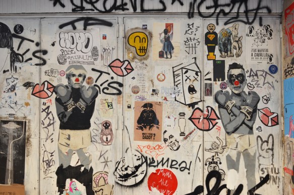 many slaps, stickers, etc, on a wall 