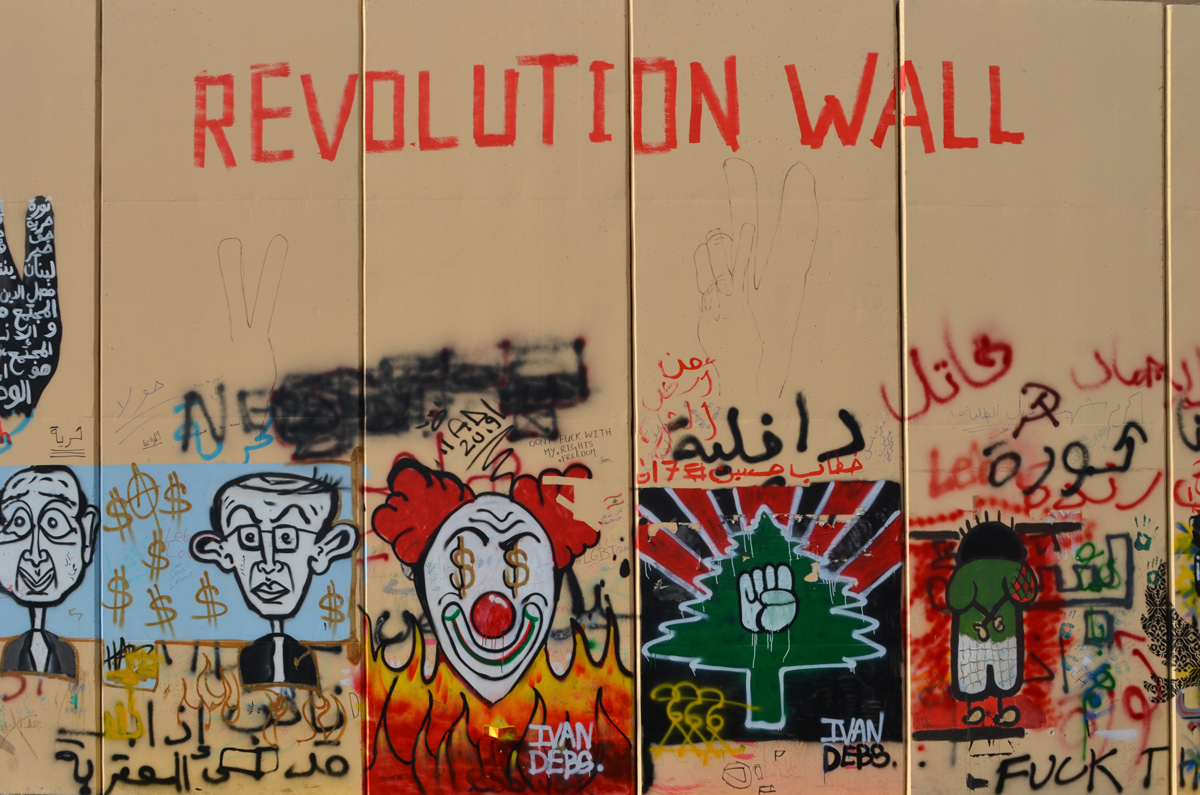 revolution wall, title of all the street art collection, on escwa wall, protest art, Beirut, clown face, green tree, closed fist, 